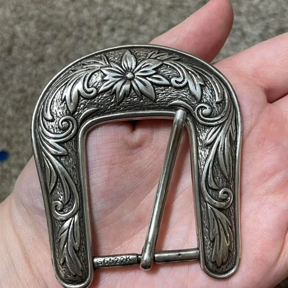 silver belt buckle with floral detailing